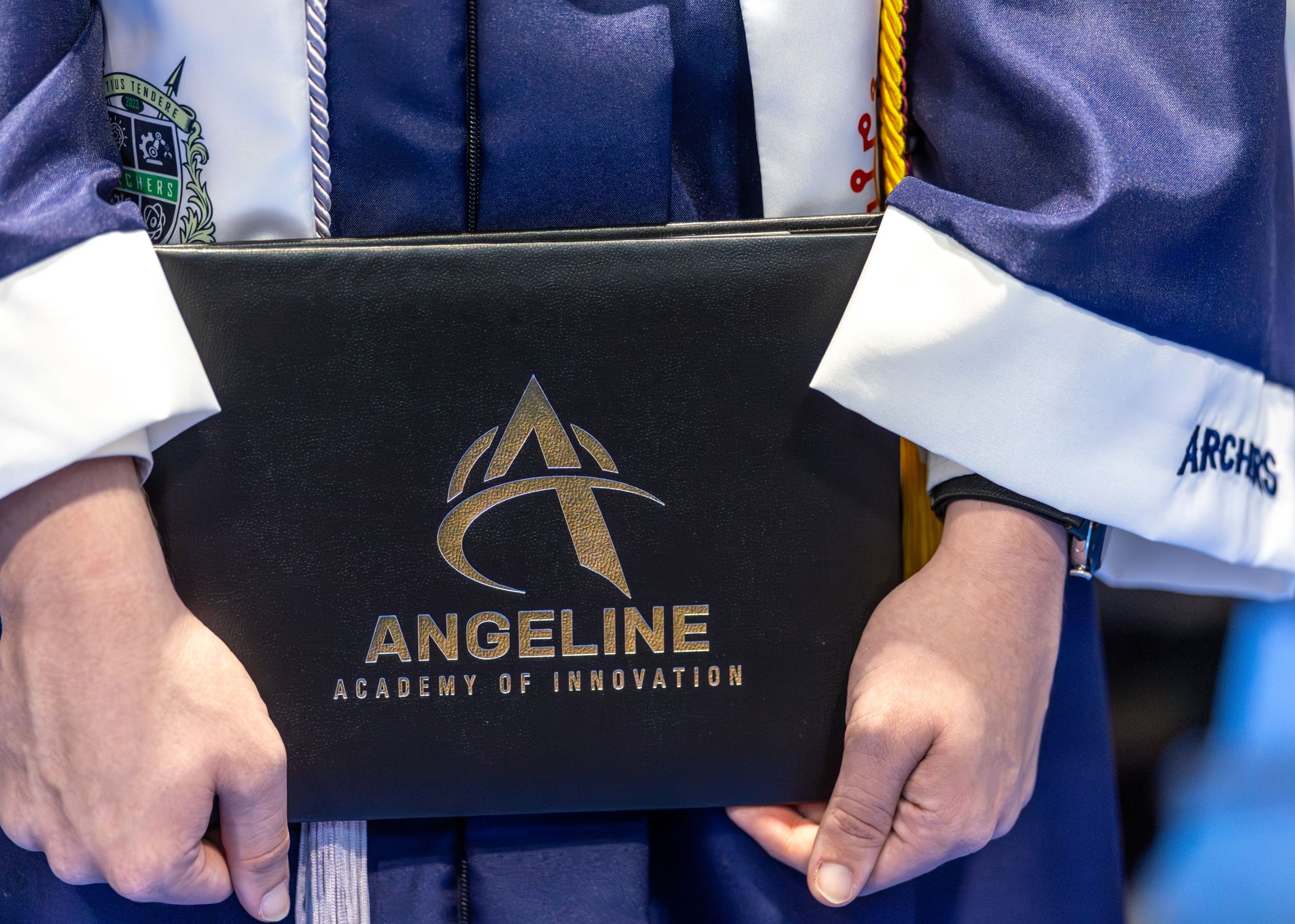 student holding logo - 