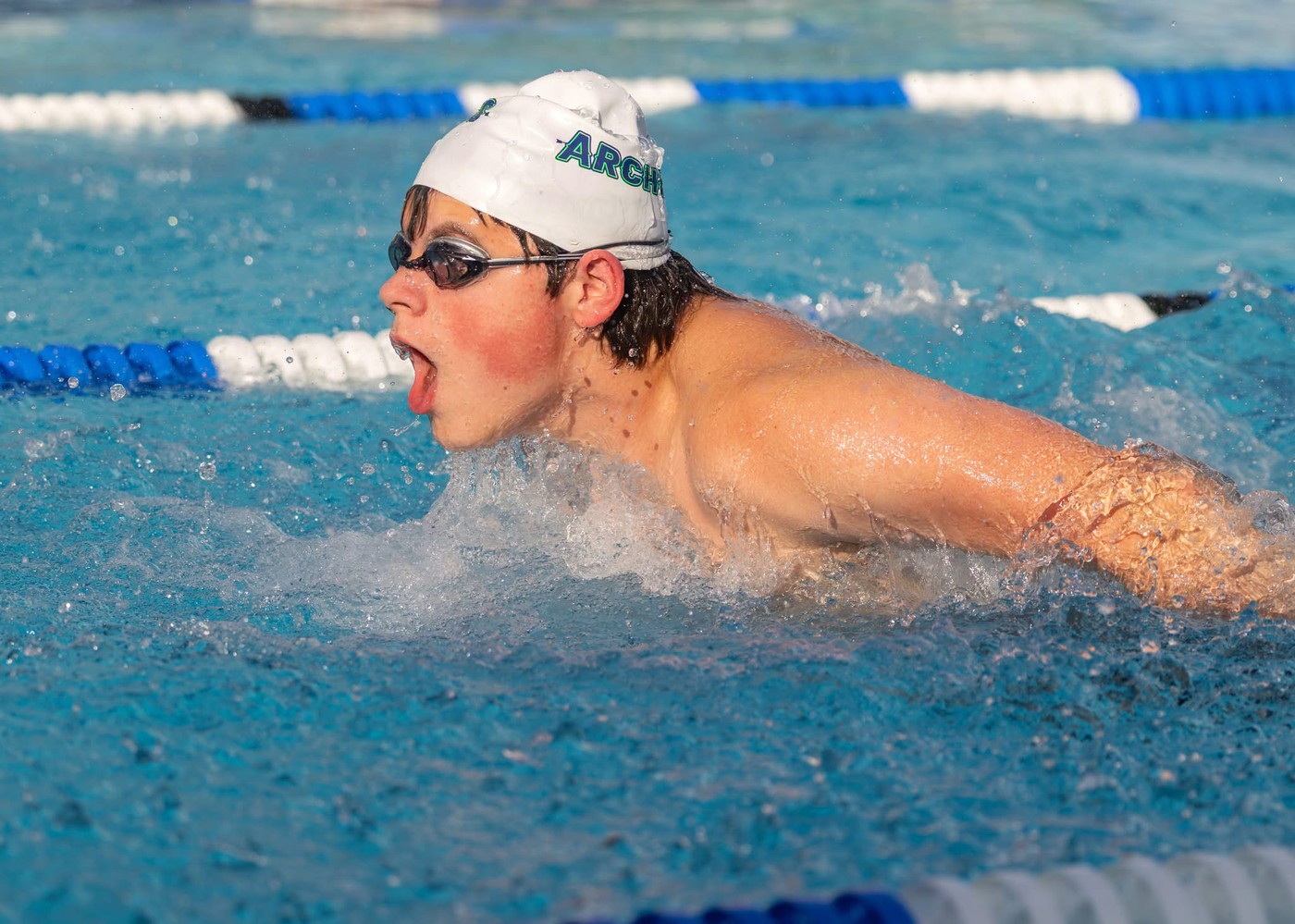 Person swimming - <p>Photos from our recent swim meet with Cypress Creek High School.</p>